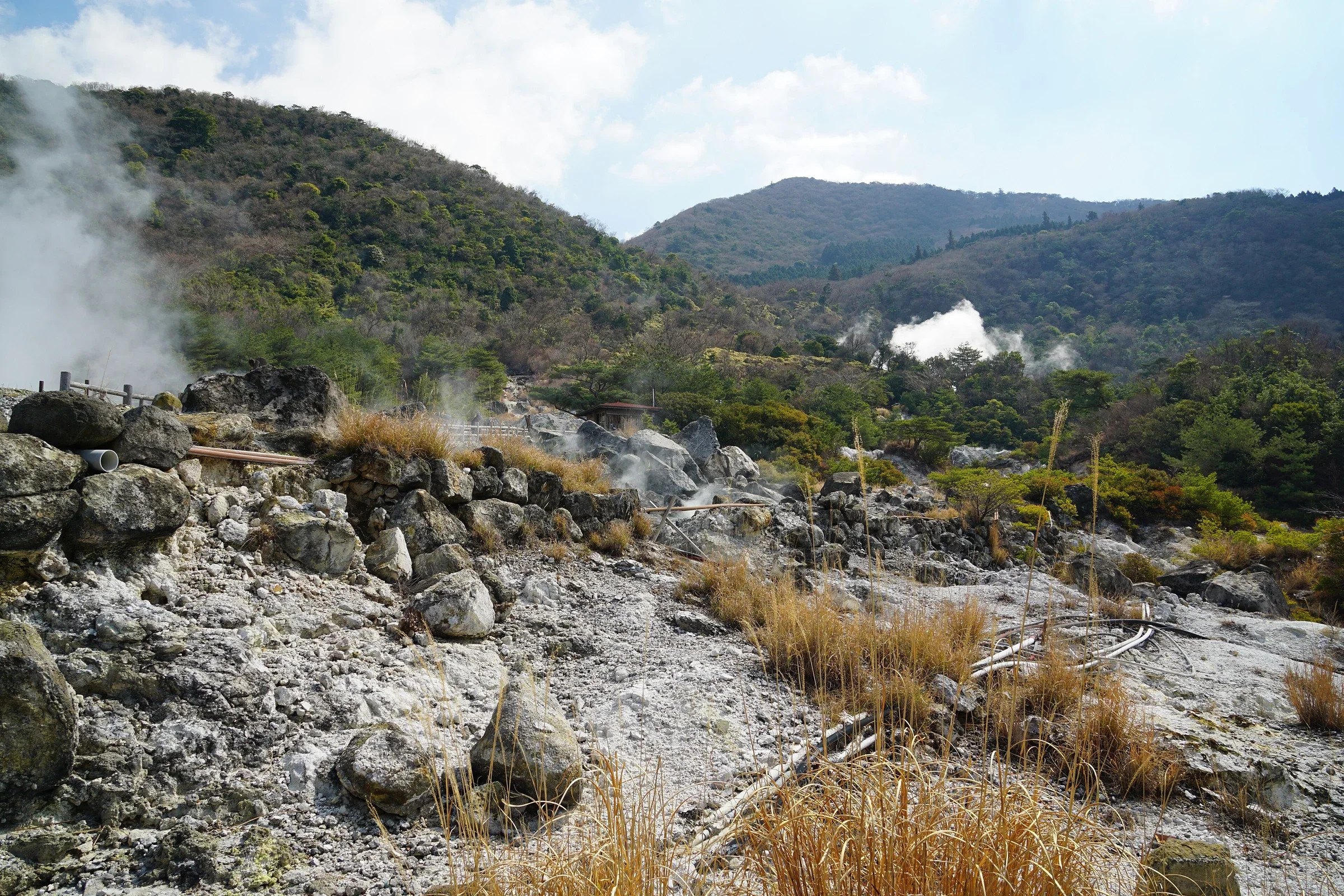 雲仙地獄灰白地面、蒸氣與周邊山坡